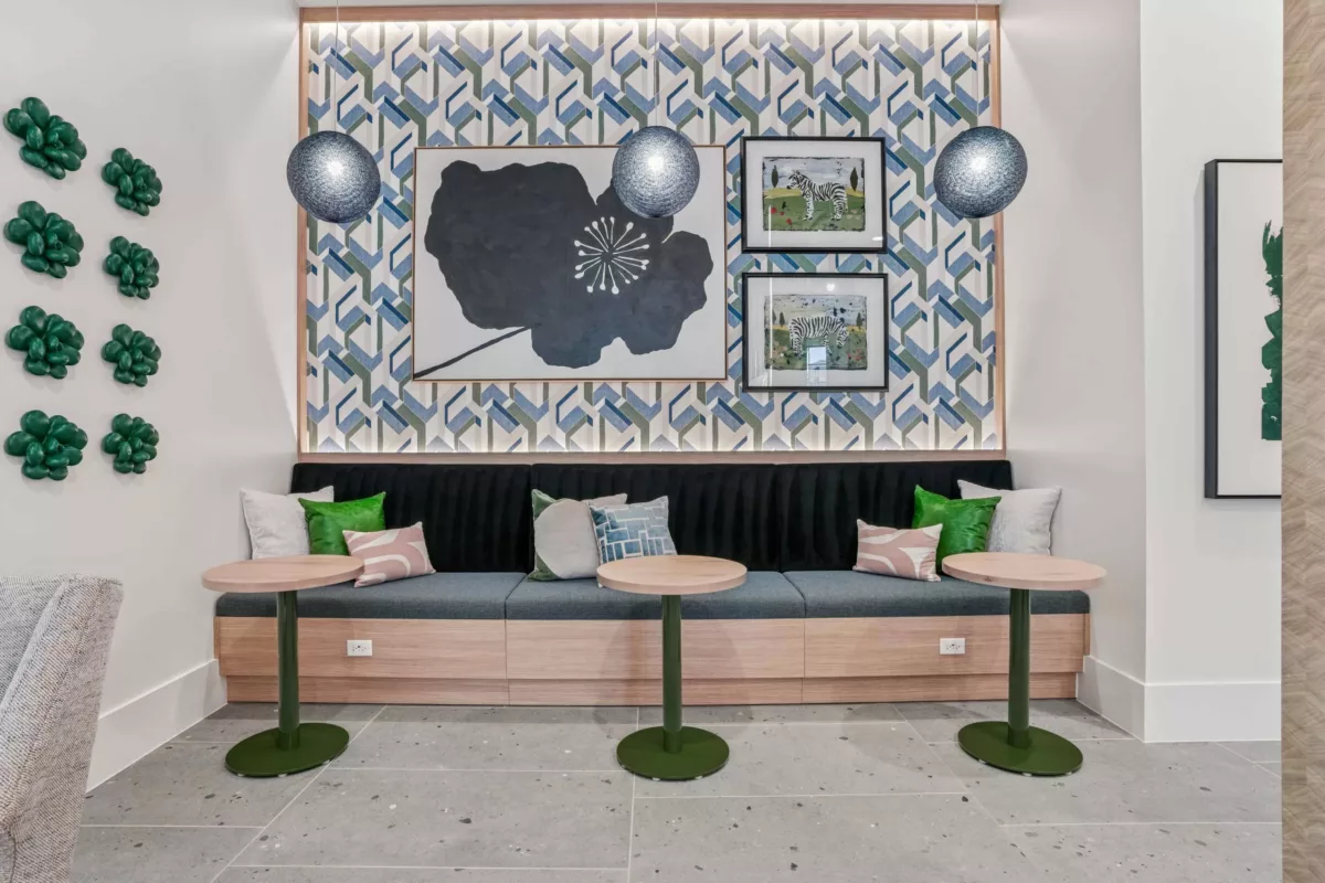 Resident bar lounge area with built-in seating, small tables, and decorative wall art.